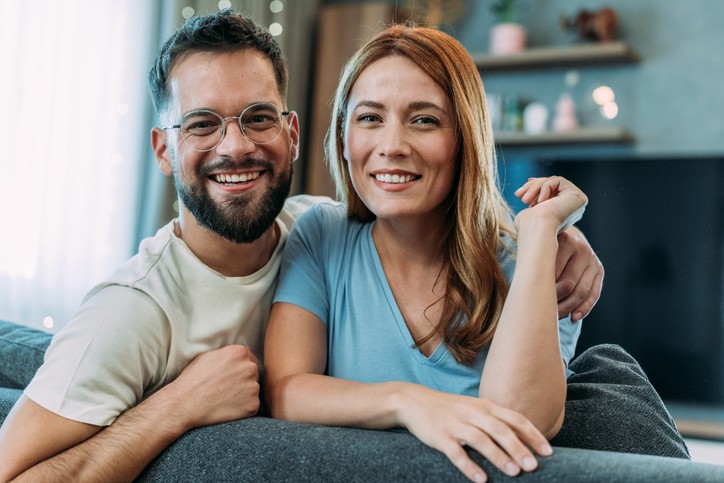 Smiling couple relaxing at home
